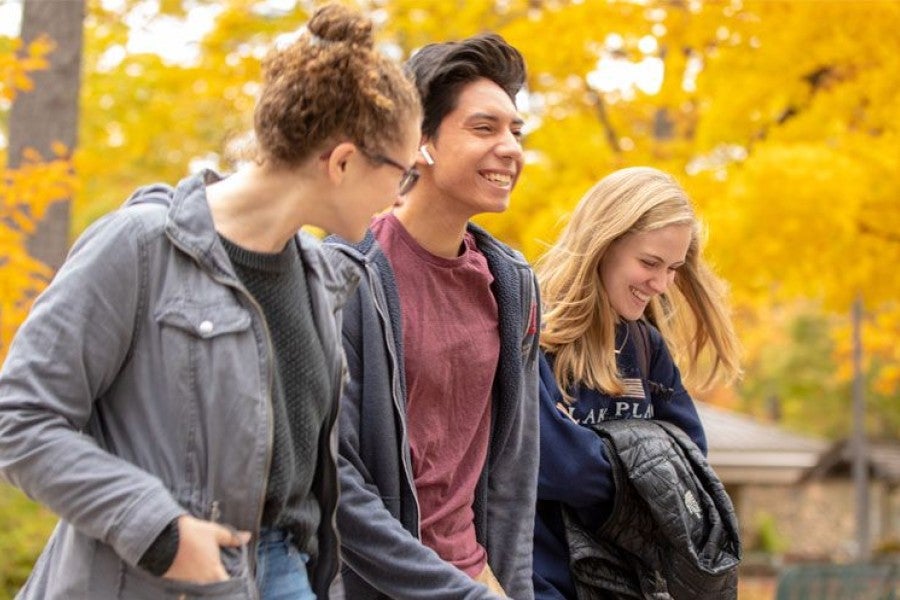 Interlochen Arts Academy students laugh as they walk to class. 